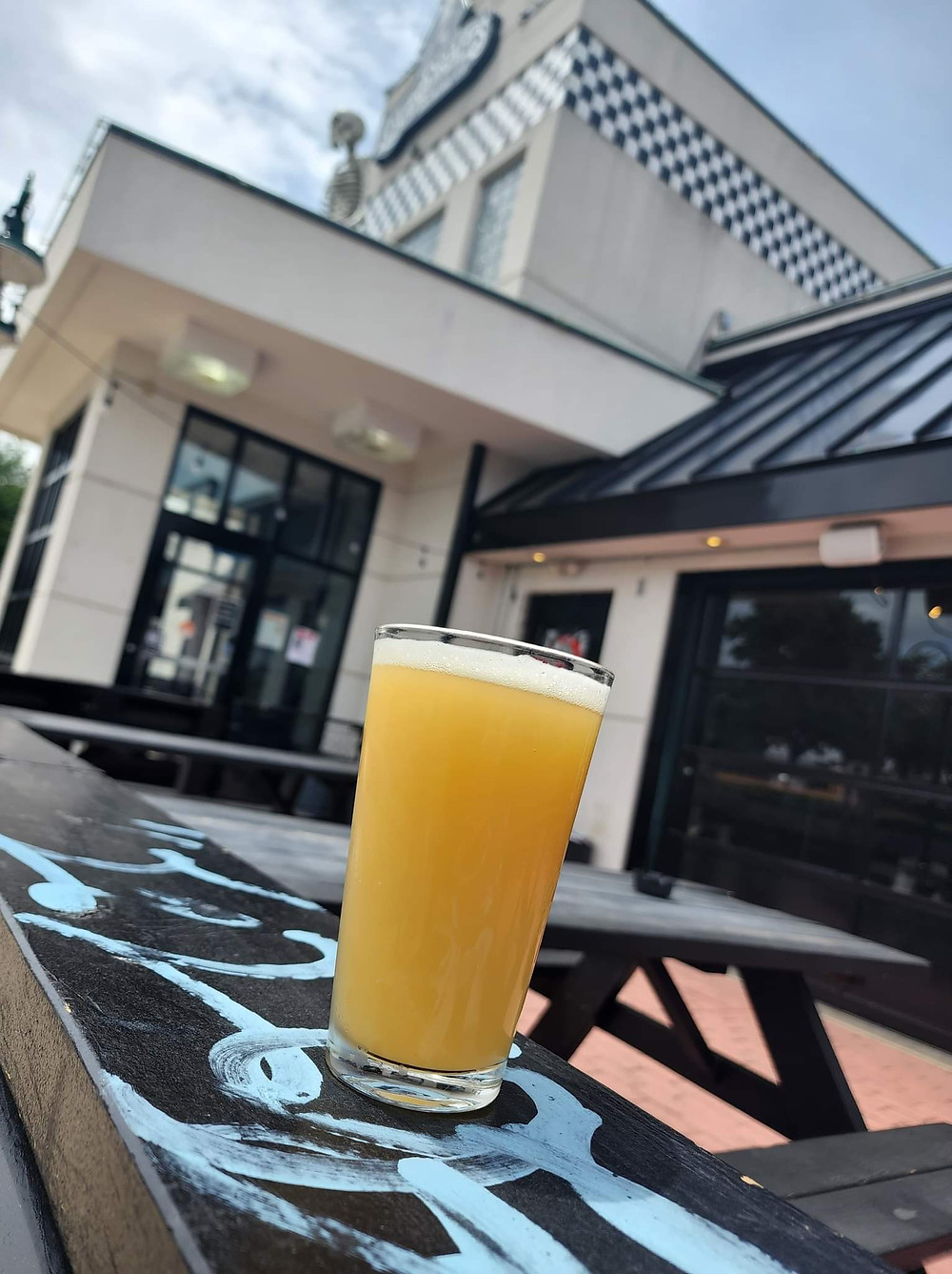 Feelin Easy #2 Sour Ale w/ Strawberry Brewed at Lovedraft's Brewing Co In Mechanicsburg Pennsylvania Perched in front of several pinball and arcade machines at the Lovedraft's brewhouse